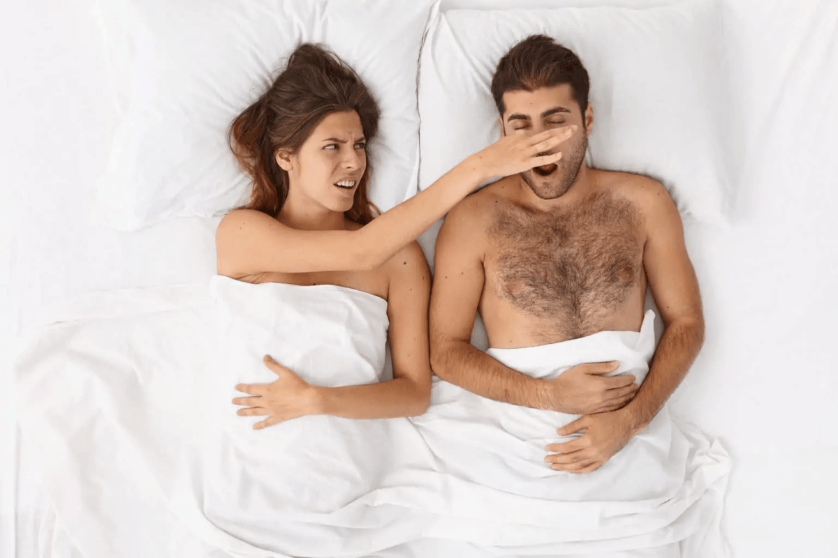 close up on couple lying in bed under white blanket 1536x1024 1
